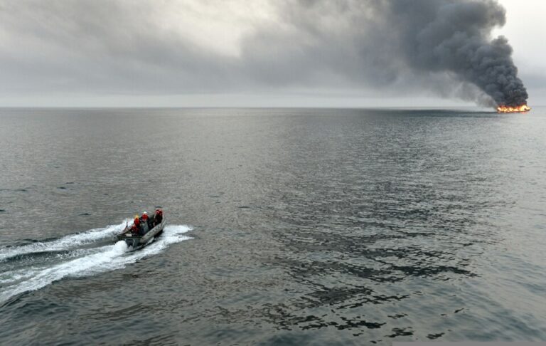 U.S._Sailors_assigned_to_the_guided_missile_destroyer_USS_William_P._Lawrence_(DDG_110)_survey_the_area_surrounding_a_burning_vessel_for_possible_survivors_March_11,_2013,_while_transiting_the_S